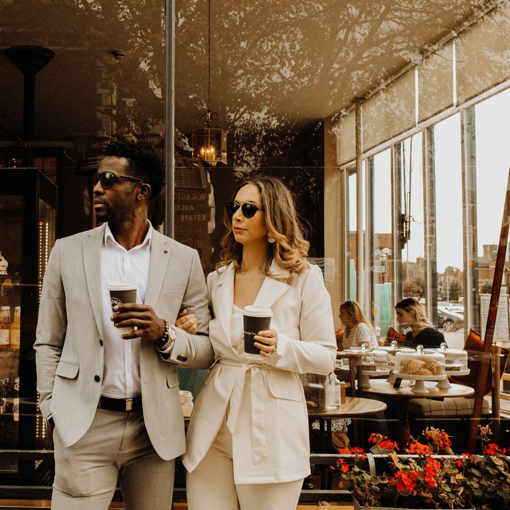 Stylish bride and groom celebrating their Portsmouth Guidhall city elopement with a coffee at their favourite cafe