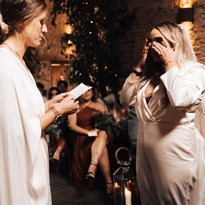 Bride becomes emotional as her wife reads wedding vows to her on their wedding day