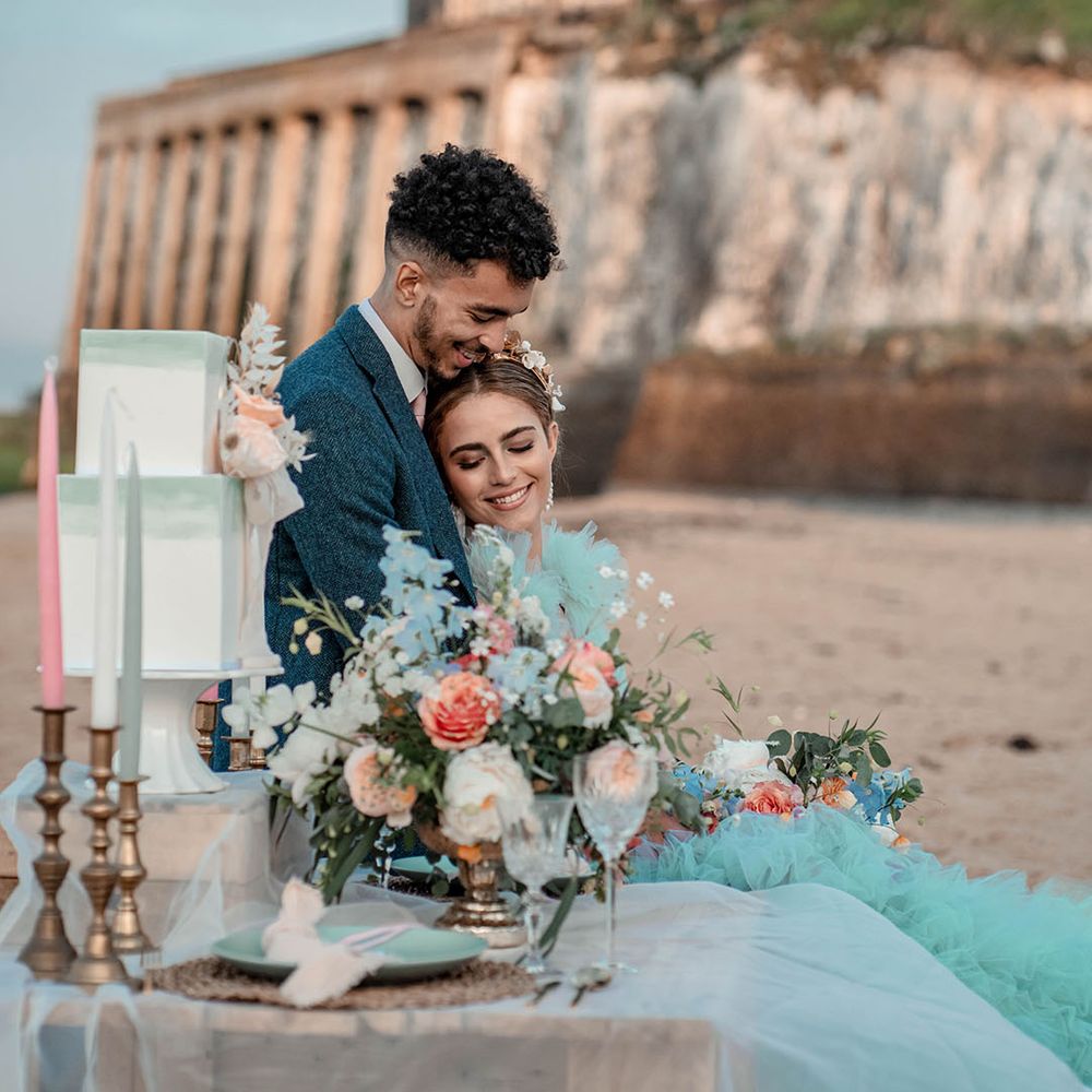 Botany Bay beach elopement in Kent with pastel coloured intimate tablescape and mint green wedding dress 