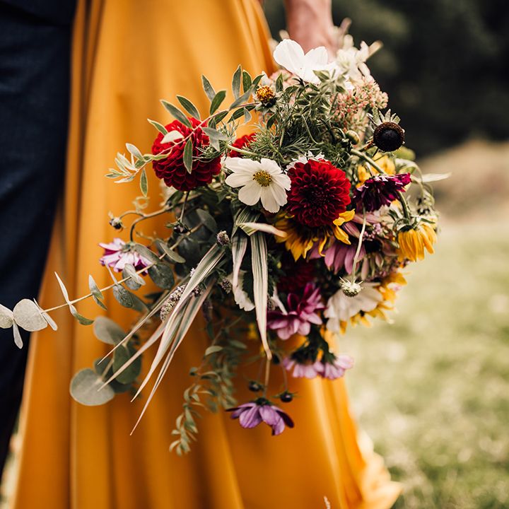 Bride holds colourful floral bouquet