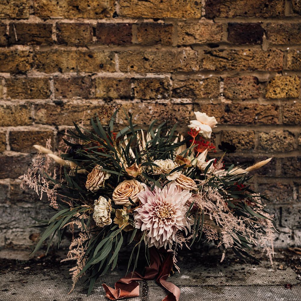Oversized wedding bouquet with caramel and dusky pink roses, carnations, dahlias and green foliage 