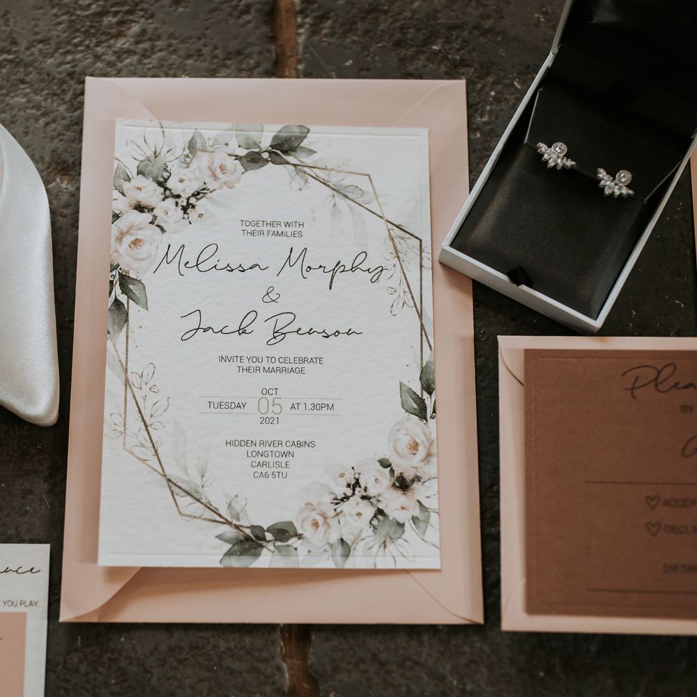 Wedding invite, earrings and white wedding shoes for flatlay at rustic barn wedding 