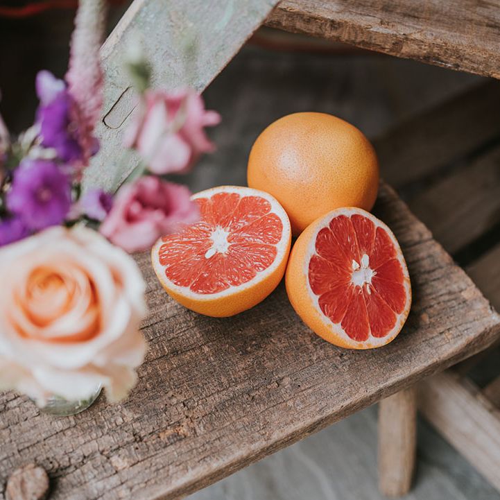 A whole and sliced grapefruit at the hydration station for wedding guests 