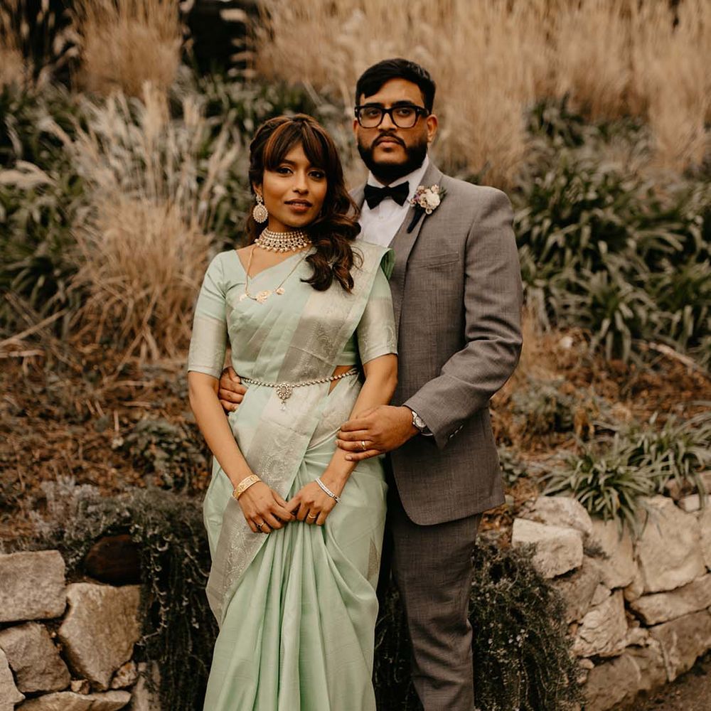 Bride in mint green saree and groom in grey suit at multicultural wedding in Richmond