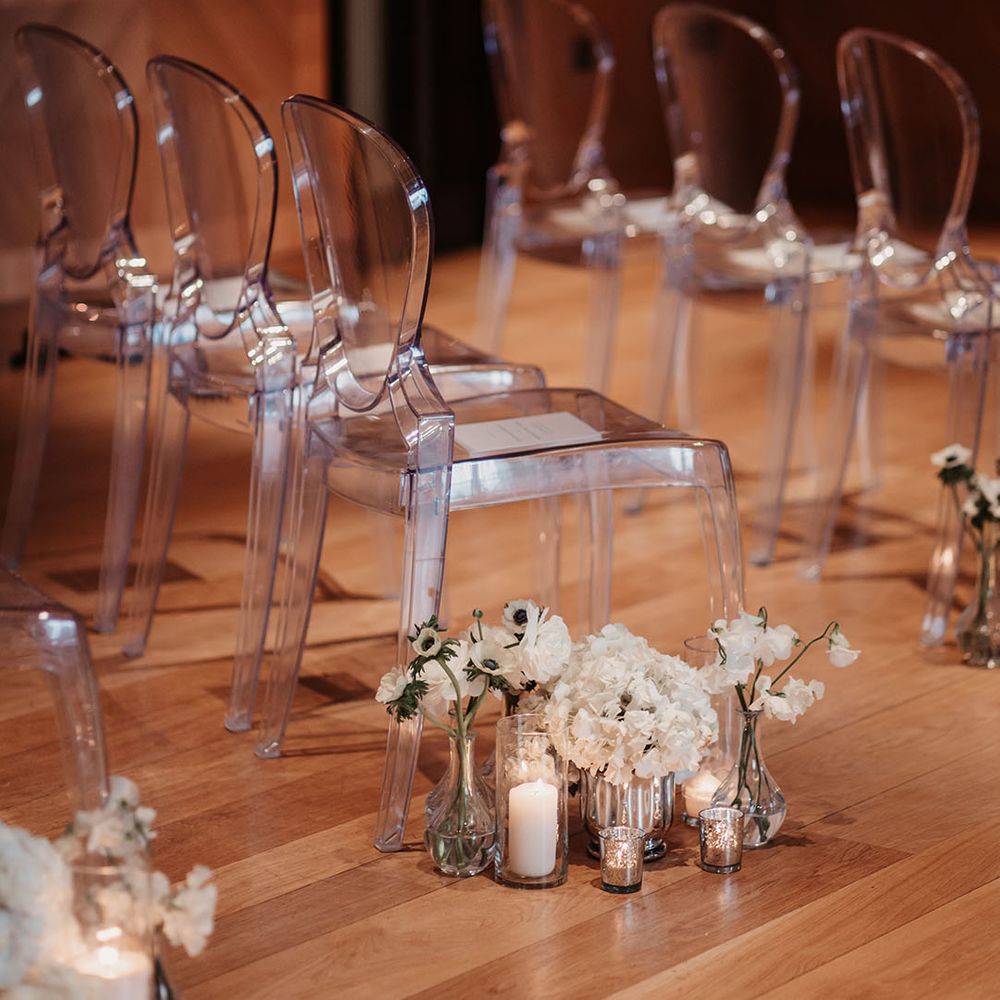 White anemones and sweet peas line the aisle with candles 
