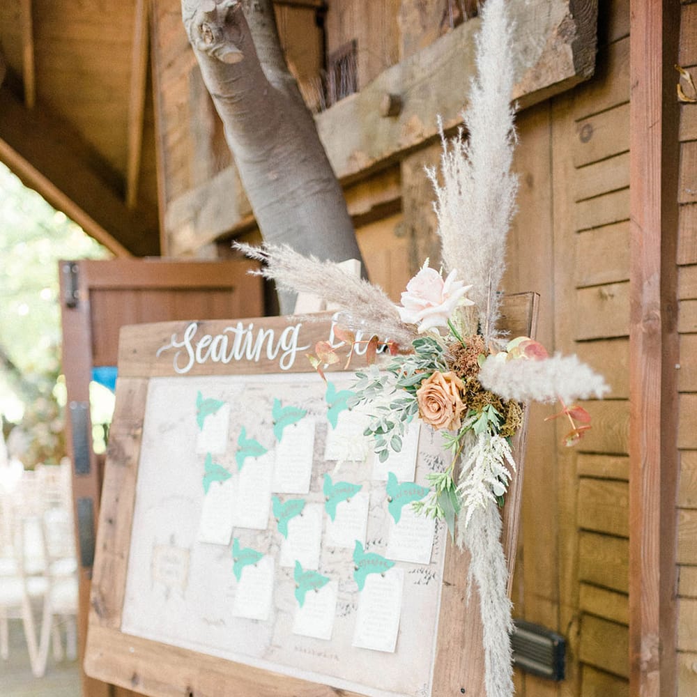Wooden wedding signage complete with dried floral decor at the Alnwick Garden Treehouse wedding venue