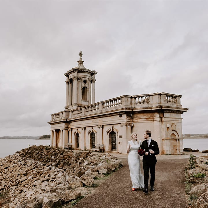 Normanton Church wedding with the bride and groom walking around the grounds together 