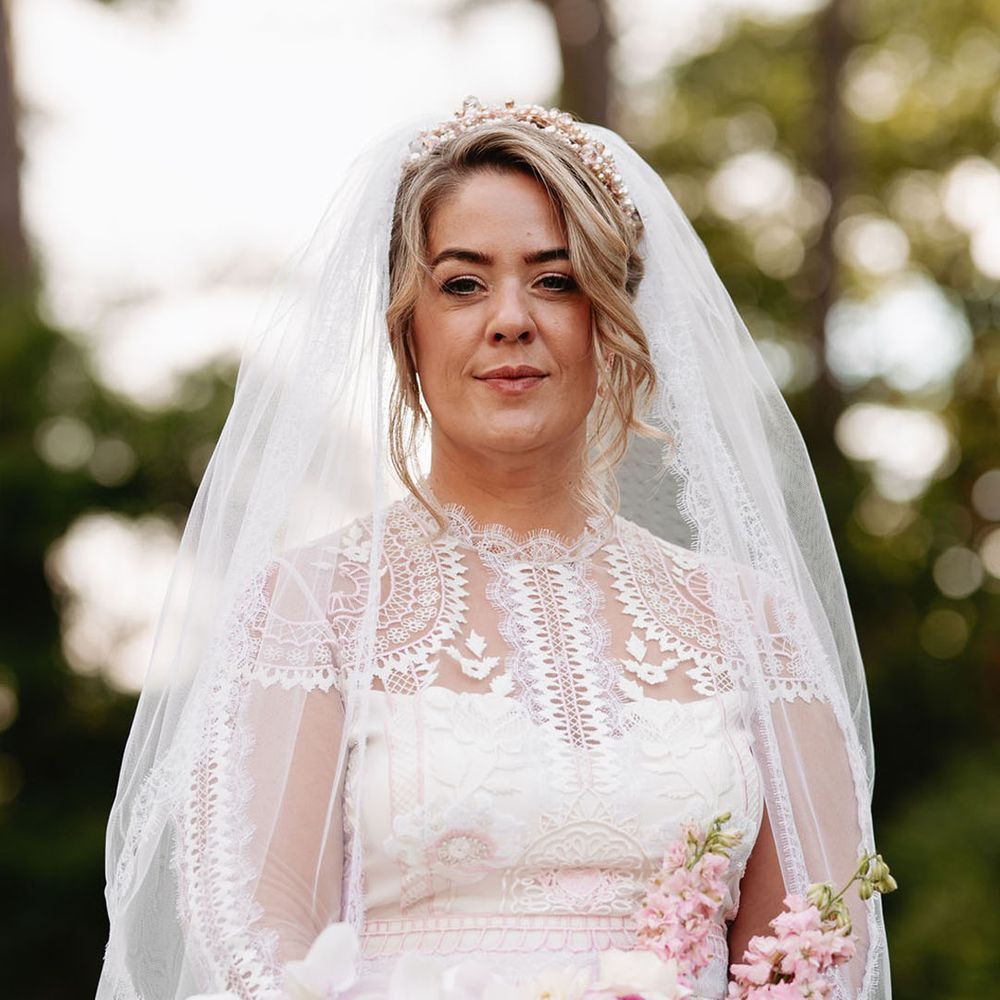 Bride in delicate long sleeve lace wedding dress by Temperley Bridal 