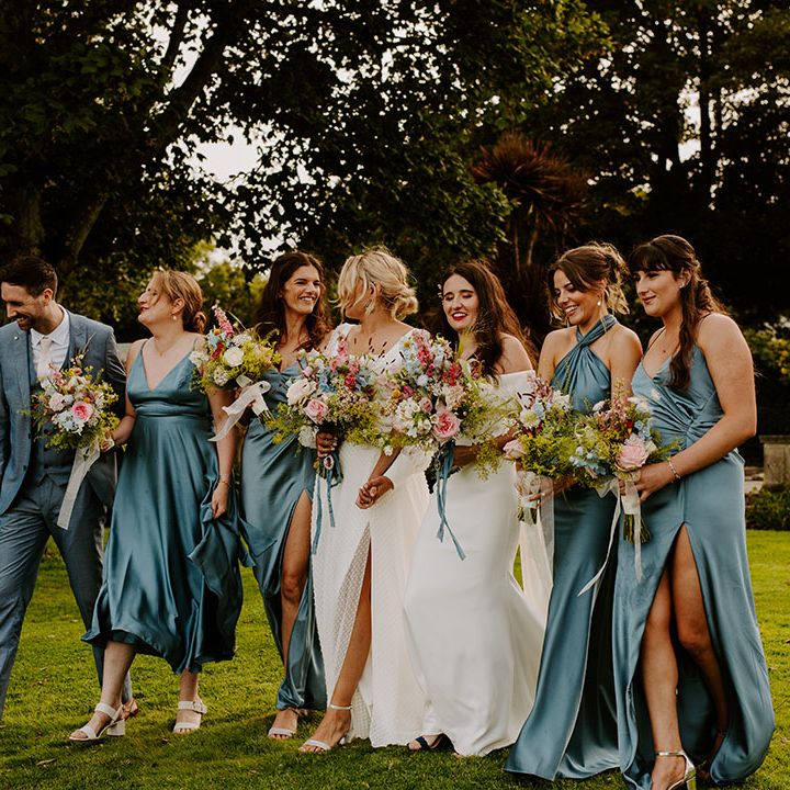 Mixed gender wedding party with bridesmaids and bridesmain in blue wedding outfits 