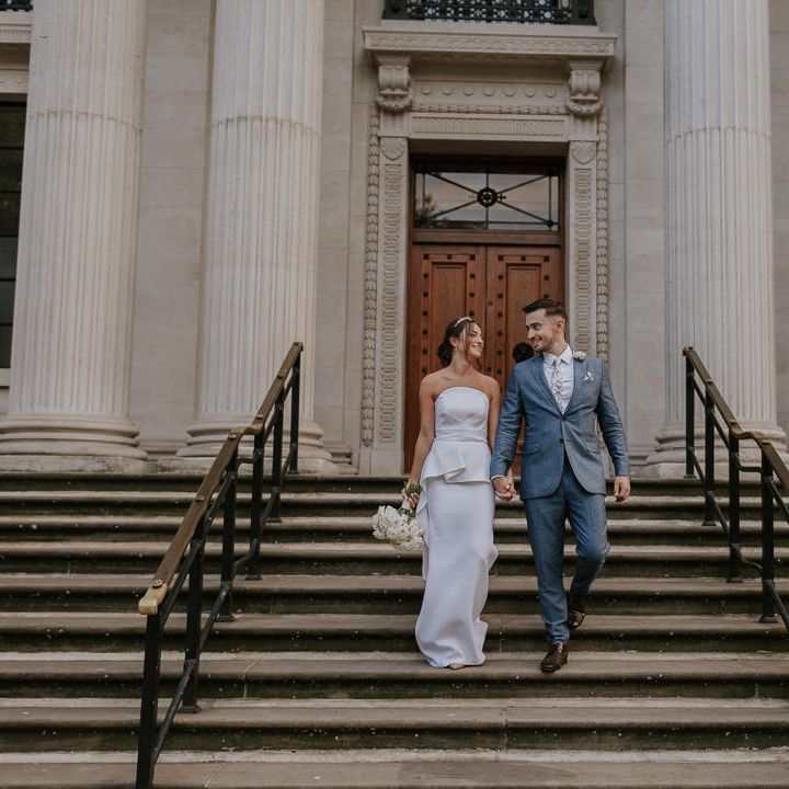Bride and groom on the steps at Old Marylebone Town Hall 