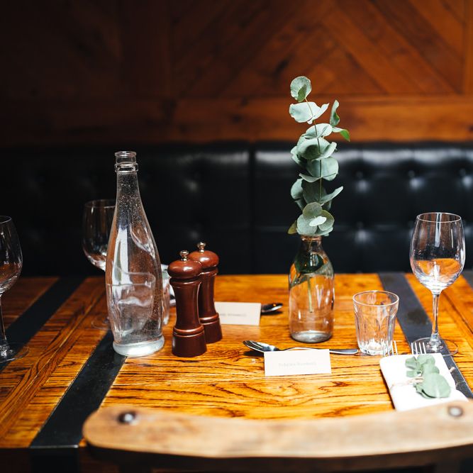 Table decor at reception with milk bottles and eucalyptus 