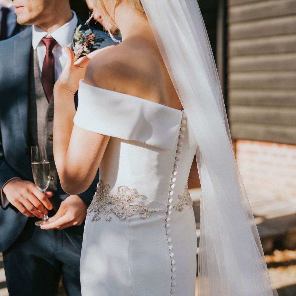 Bride wears buttoned down wedding dress 