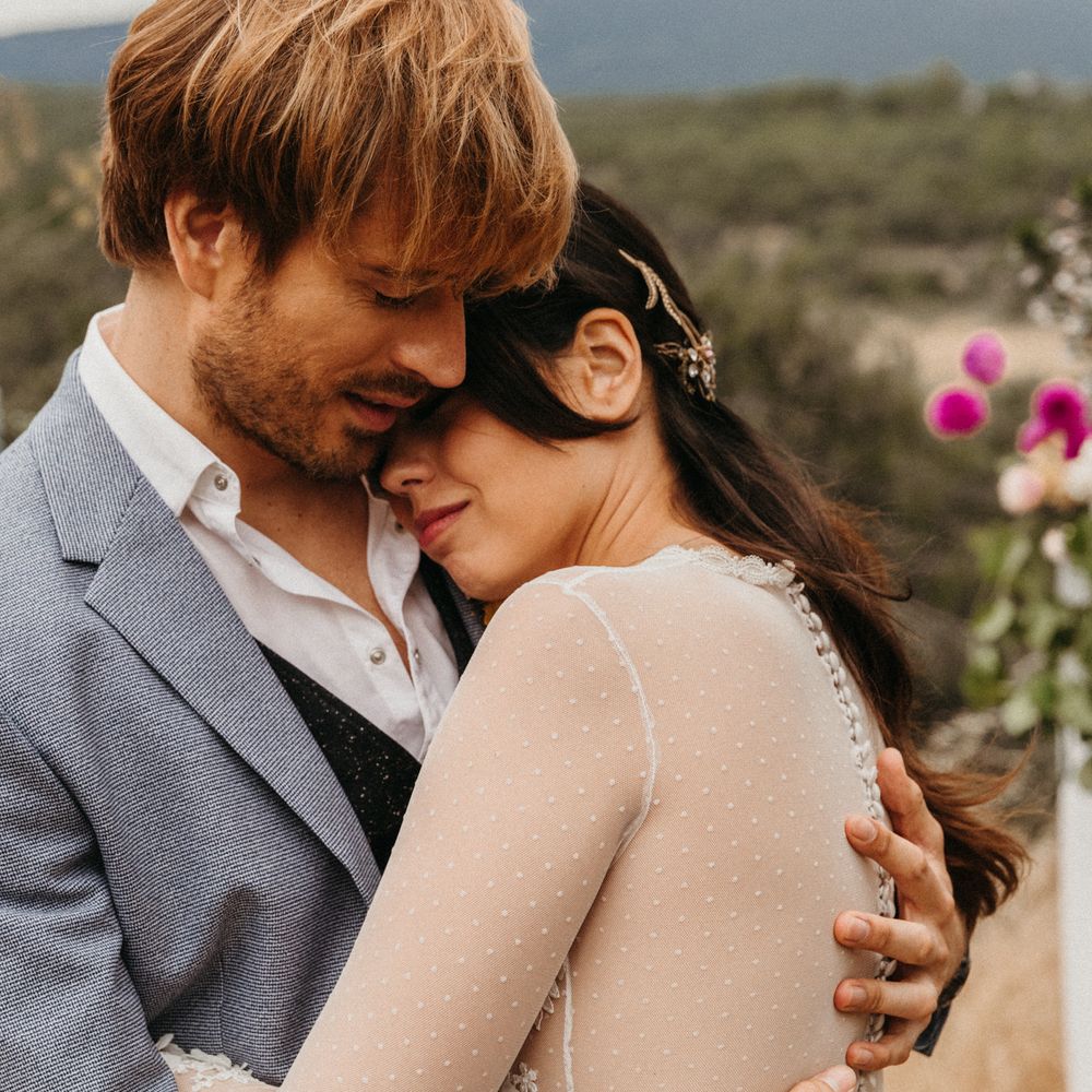 Bride cuddles into groom during their elopement in Madrid 