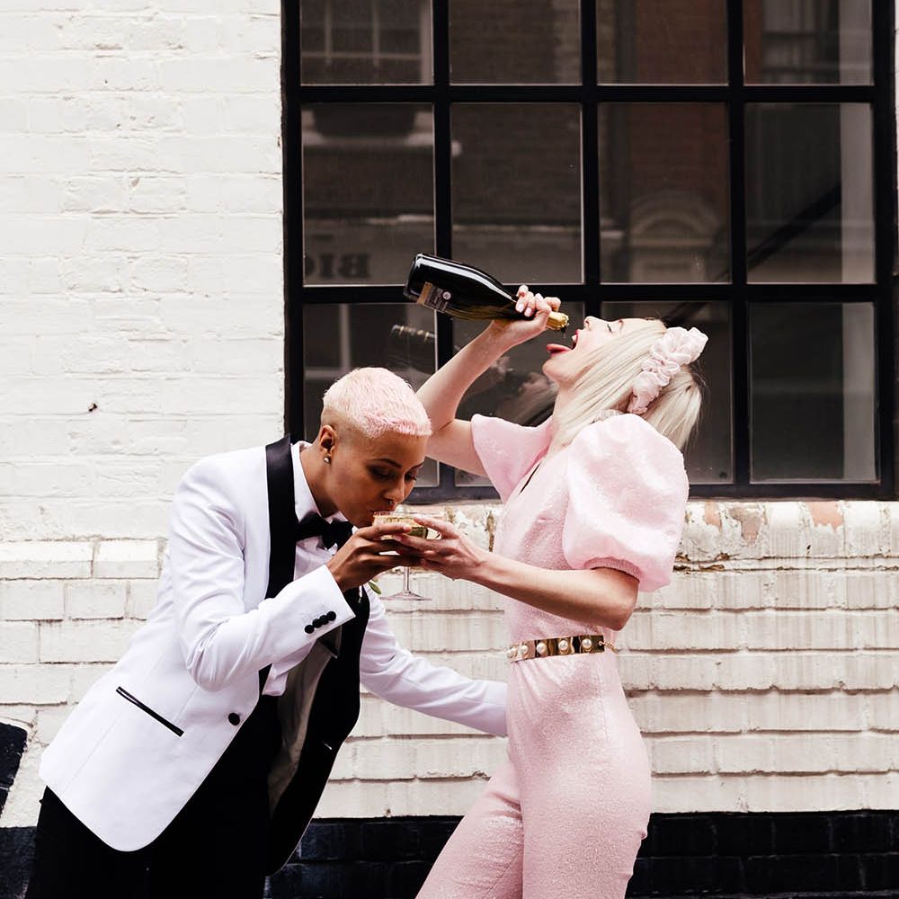 LGBTQ couple drinking champagne in the streets of Shoreditch 