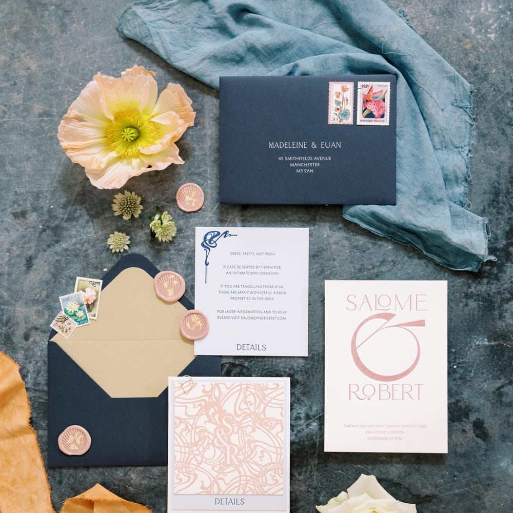 Art Nouveau wedding stationery complete in pastel colours on marble background