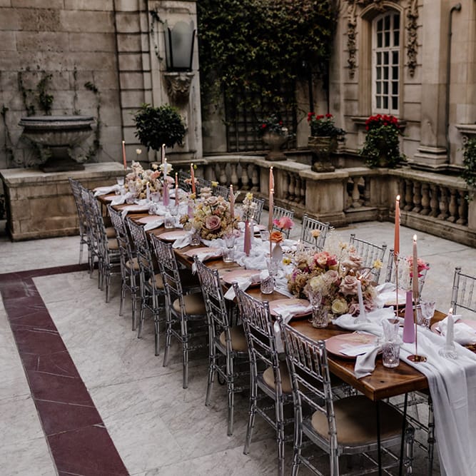 Outdoor wedding tablescape at Dartmouth Weddings venue in Mayfair with pink flowers and taper candles 