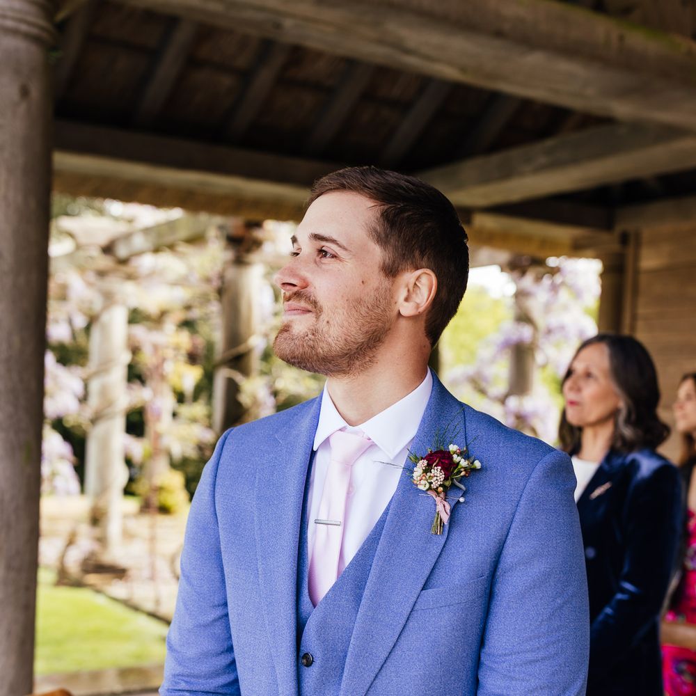 Groom wears pale blue suit on wedding day