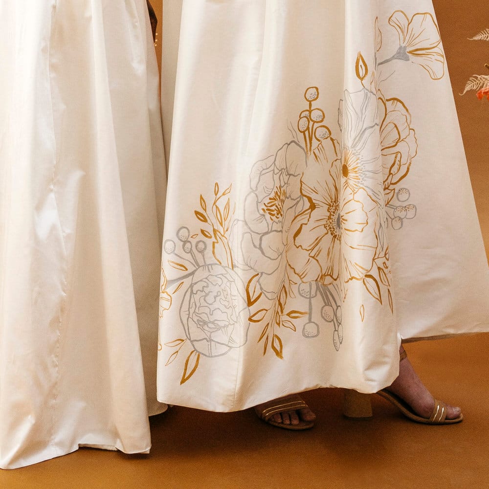 Customised hand painted gold and silver floral illustrations on wedding skirts by Bee Davies