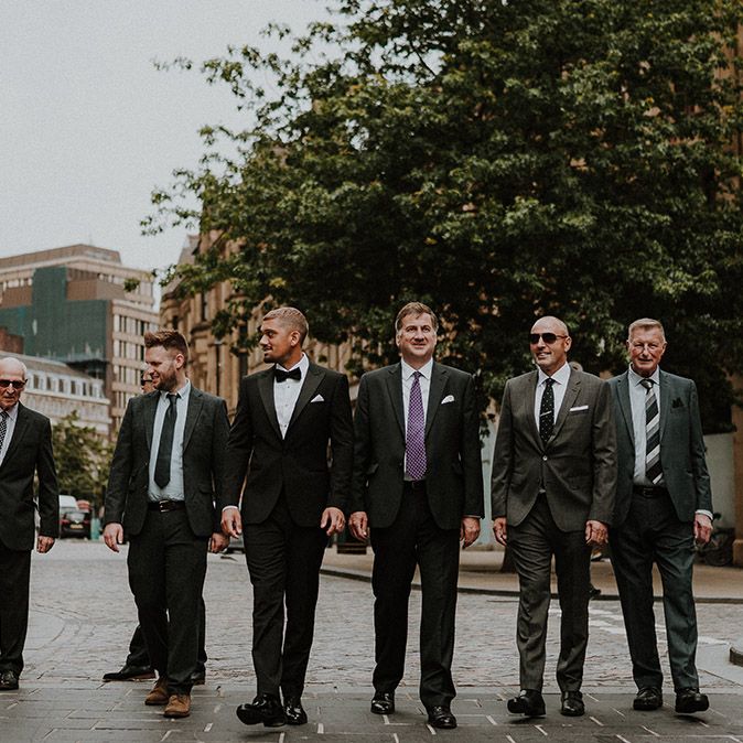 Groomsmen walking through the streets of Sheffield 