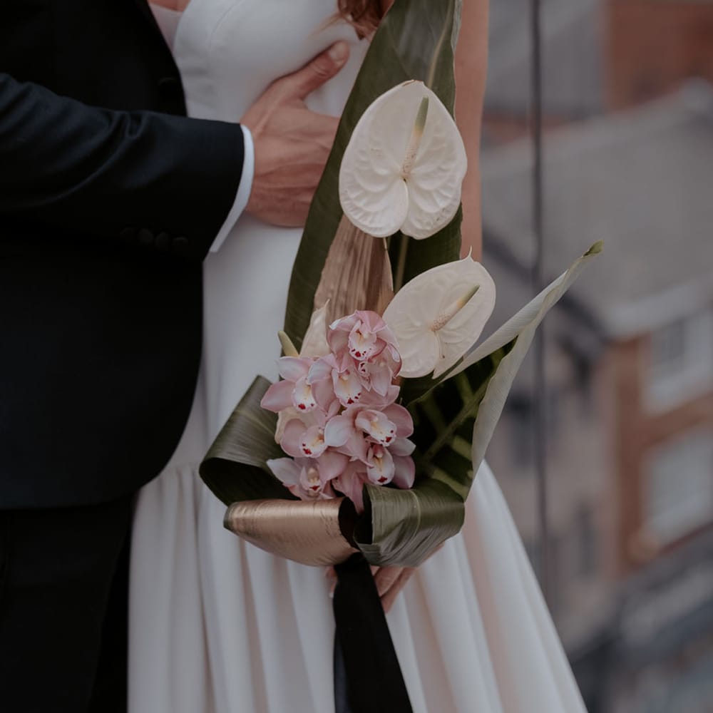 Tropical wedding bouquet with white anthuriums and orchids 
