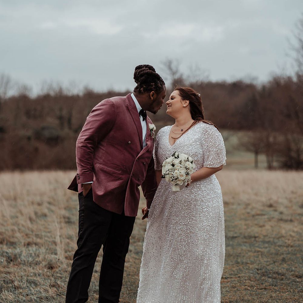 Bride & groom kiss on their wedding day outside 