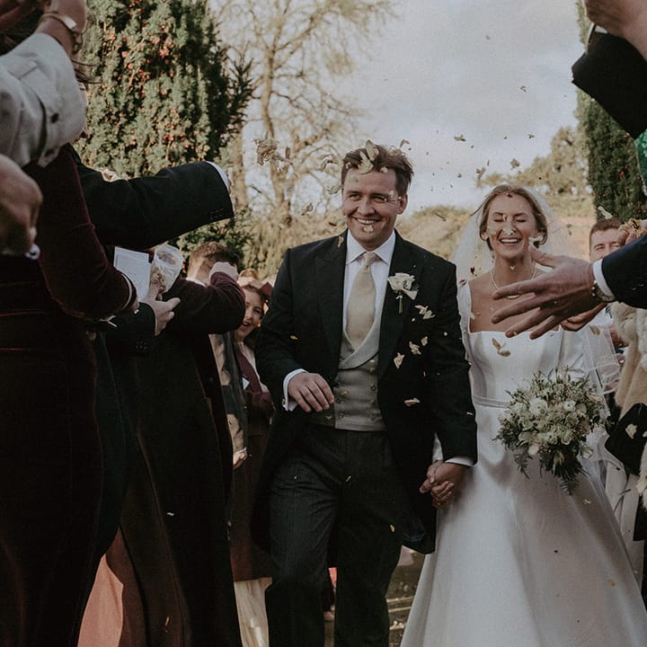 Bride and groom amidst confetti at Hedsor House wedding