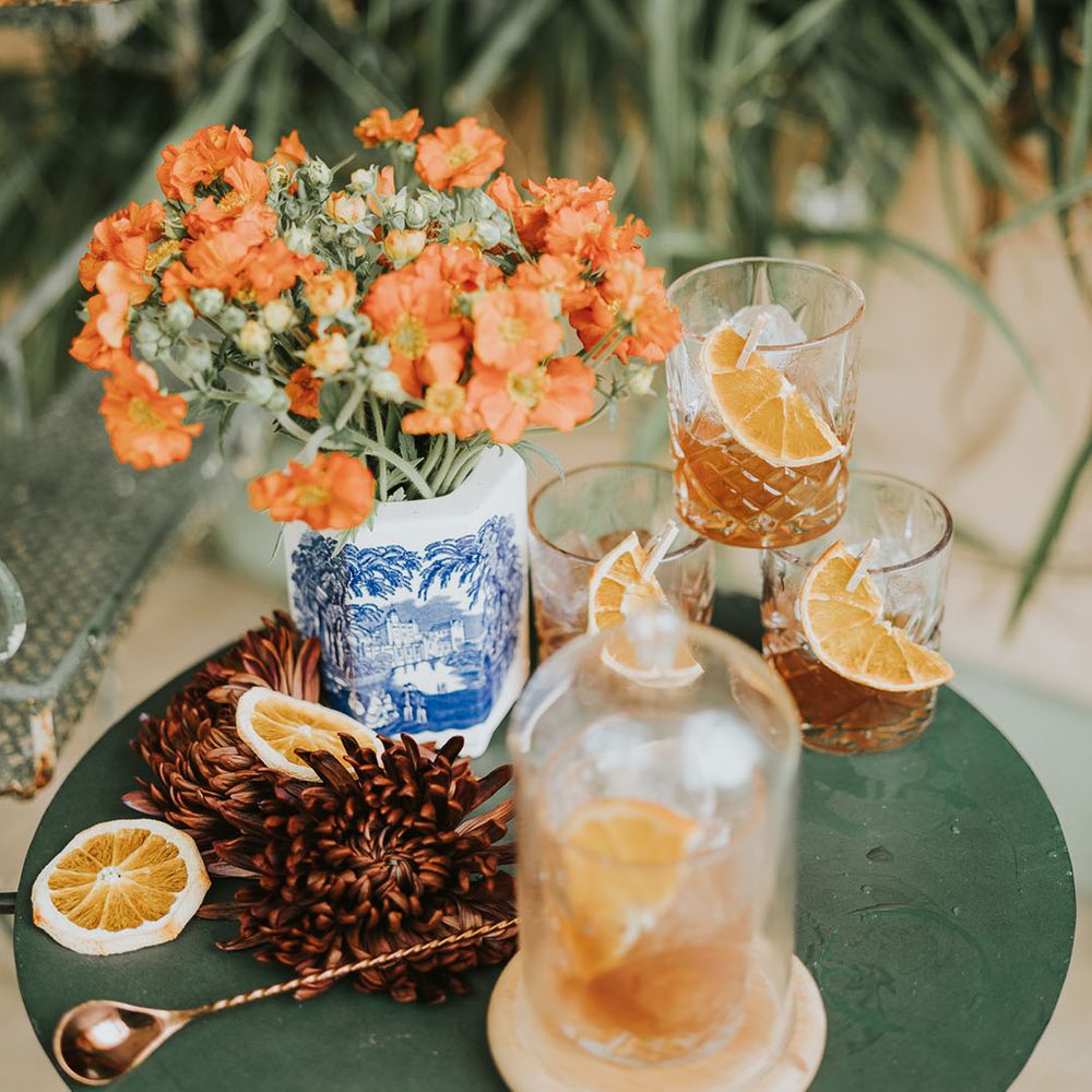 Table of orange cocktail with orange flowers 