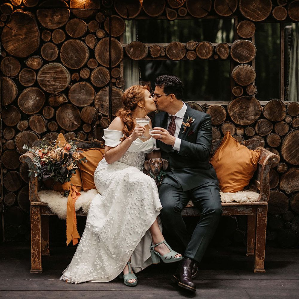Bride wears Esska Shoes and sits beside her groom in Suit Supply bespoke suit