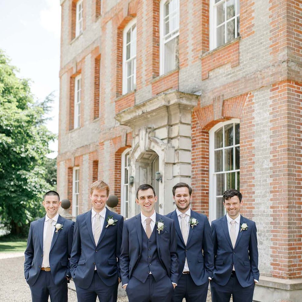 Groom and groomsmen in navy suits and blush pink ties at Ardington House wedding 