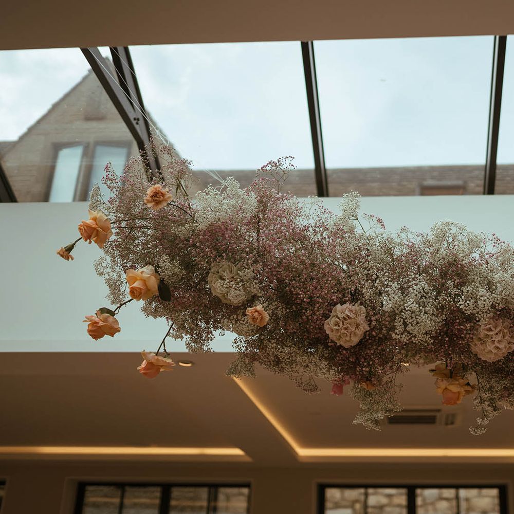 hanging pink and yellow roses, hydrangeas and gypsophila flower cloud 