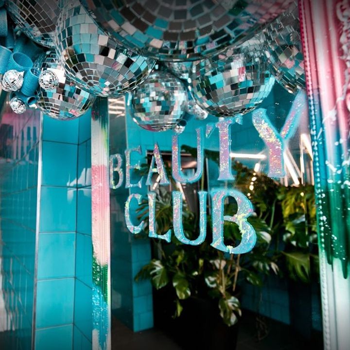 The salon interior at Beauty Club London, featuring the entrance hallway with stairs and disco balls 