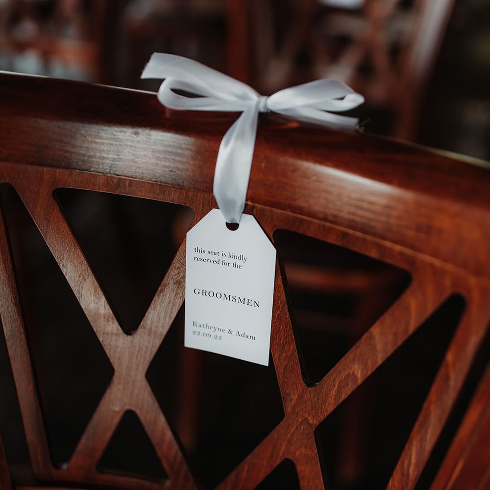 Minimalist wedding chair tag that reserves the chairs for certain guests 