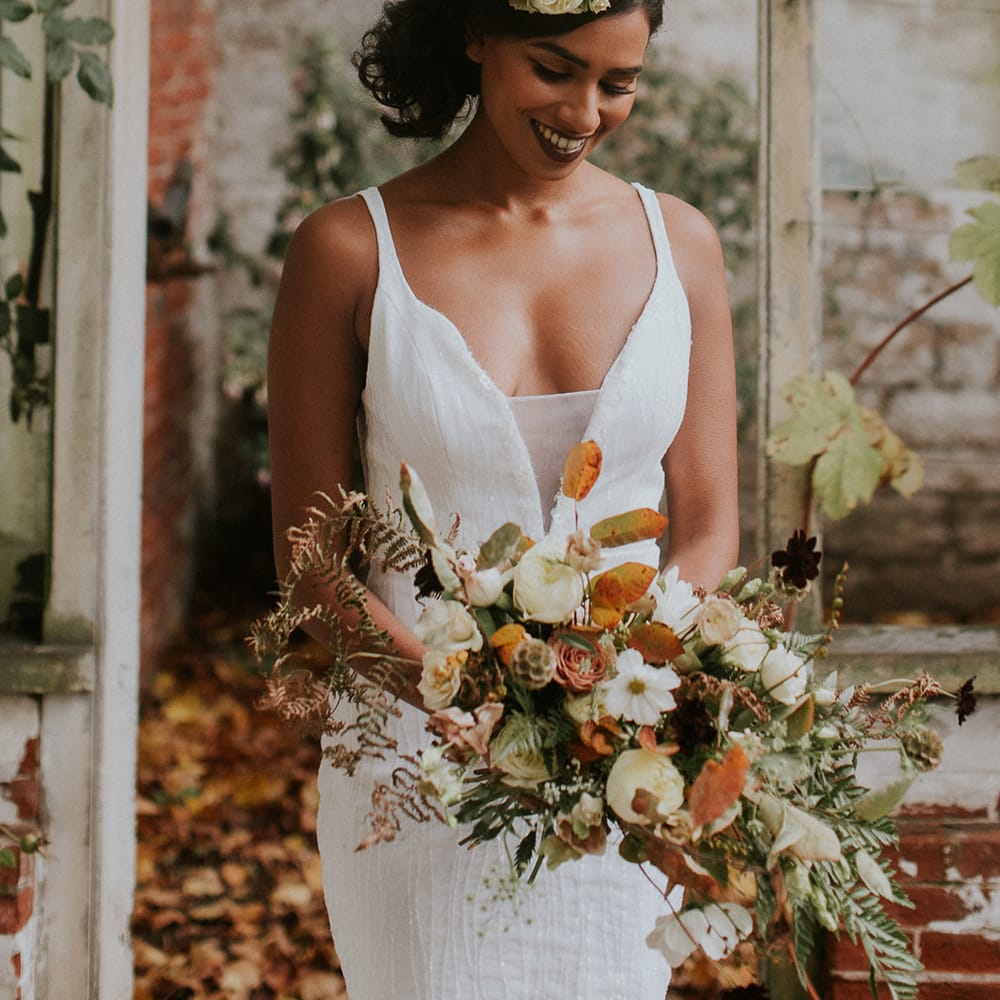 Beautiful bride with autumn floral headdress and wedding bouquet 