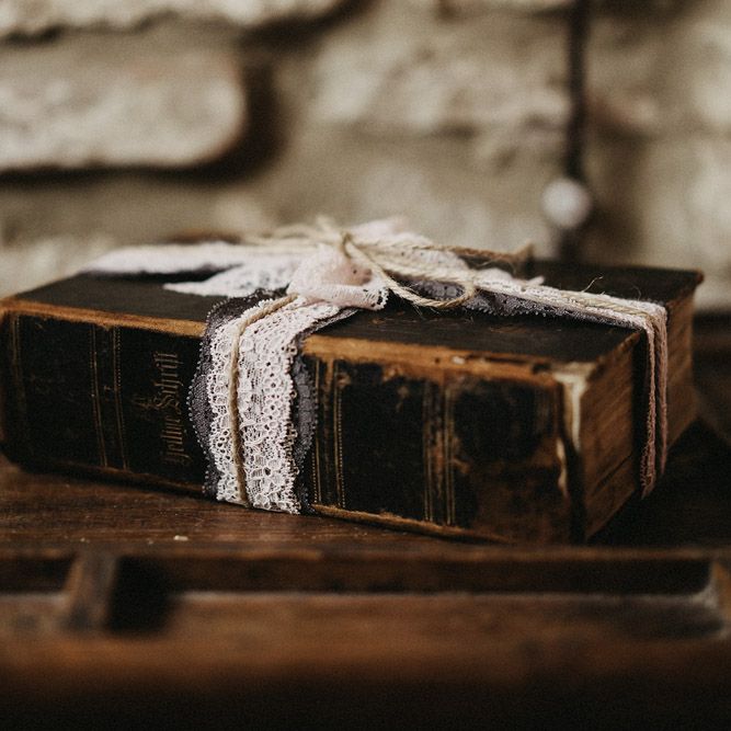 Old leather book with lace wrapped in a bow on the outside