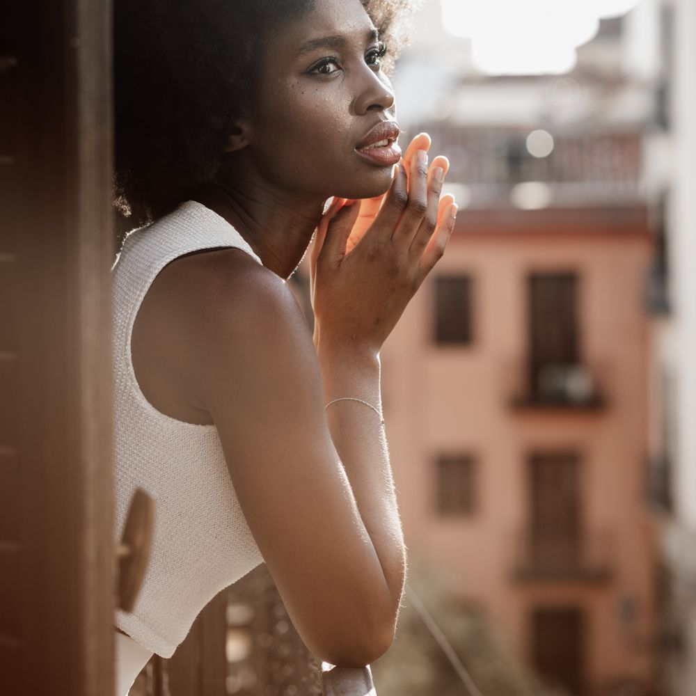 Bride stood on balcony in white top 