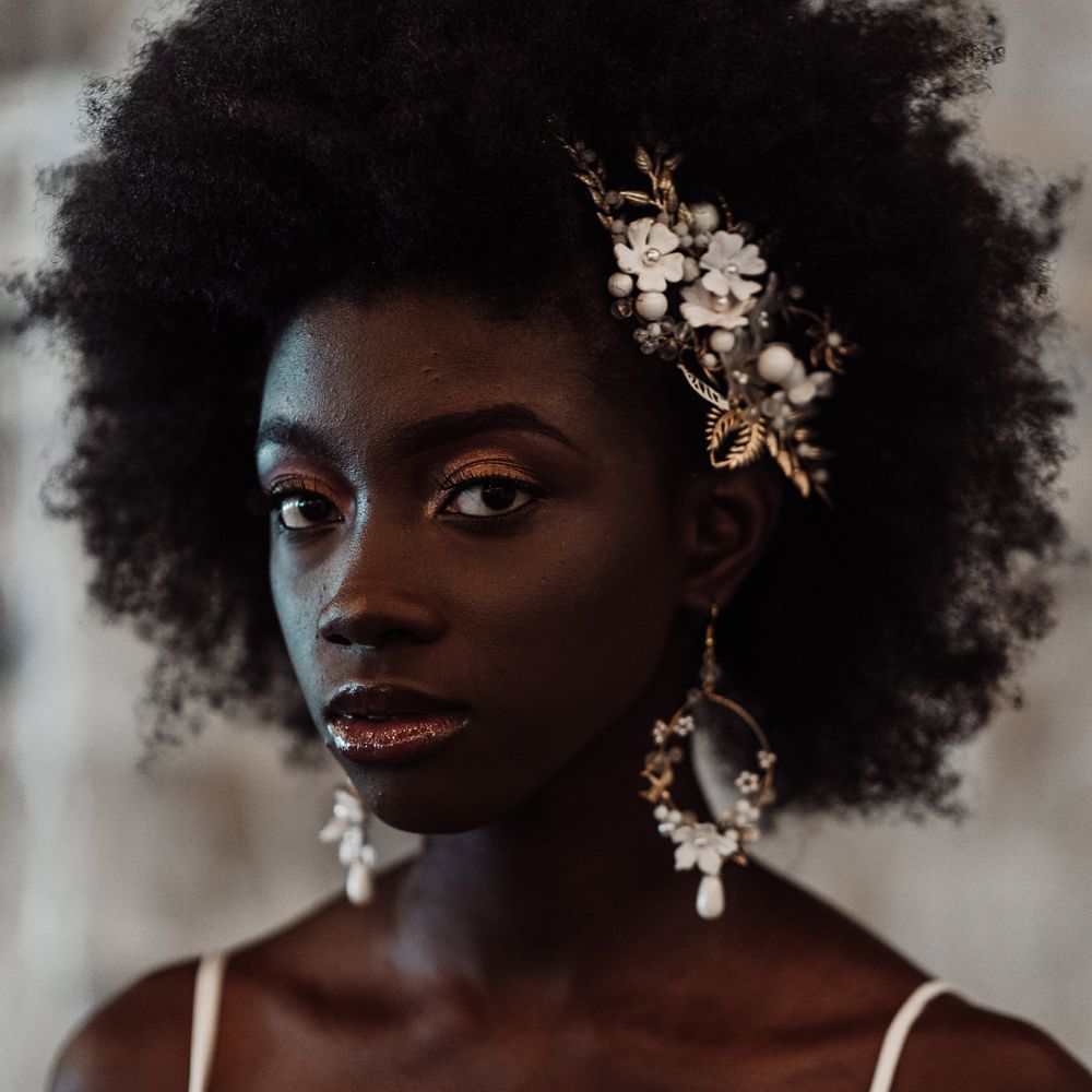 Black bride with afro hair with jewel earrings and hair accessory 