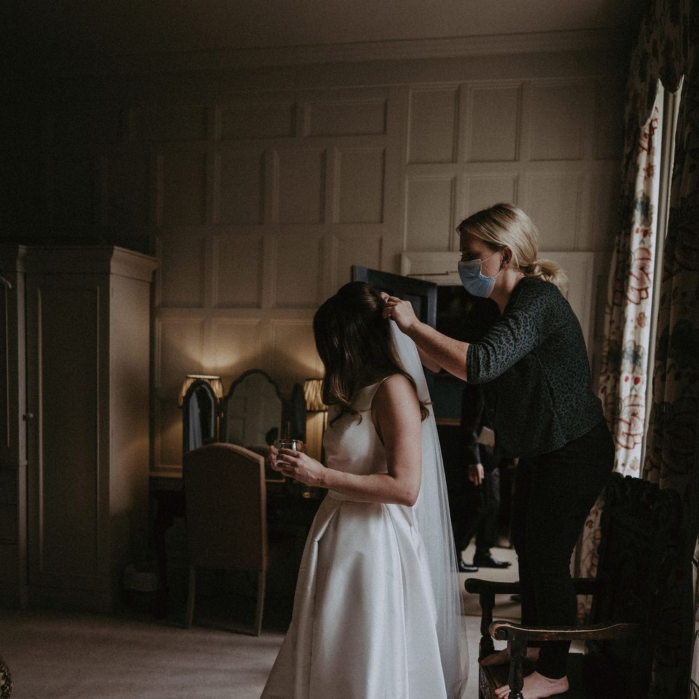 Bride has her veil applied on the day of her wedding