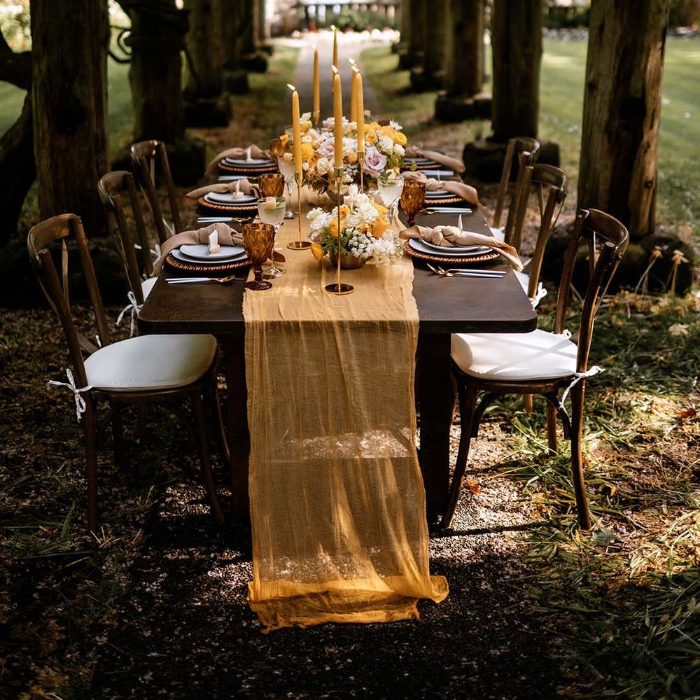 Outdoor reception with gold, brown and honey yellow wedding decor and details 