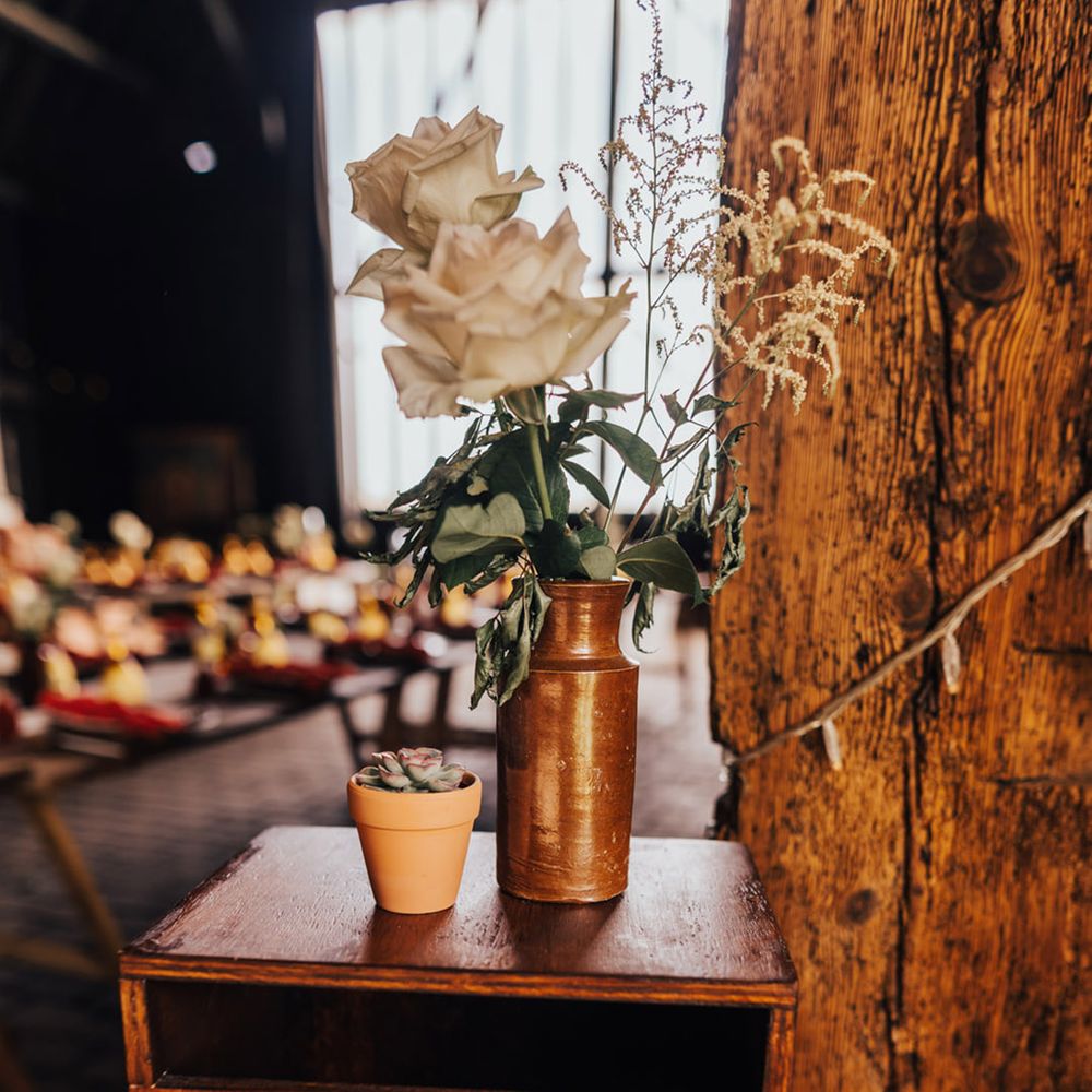 Wooden plagues & pale open roses at Elmley Nature Reserve wedding