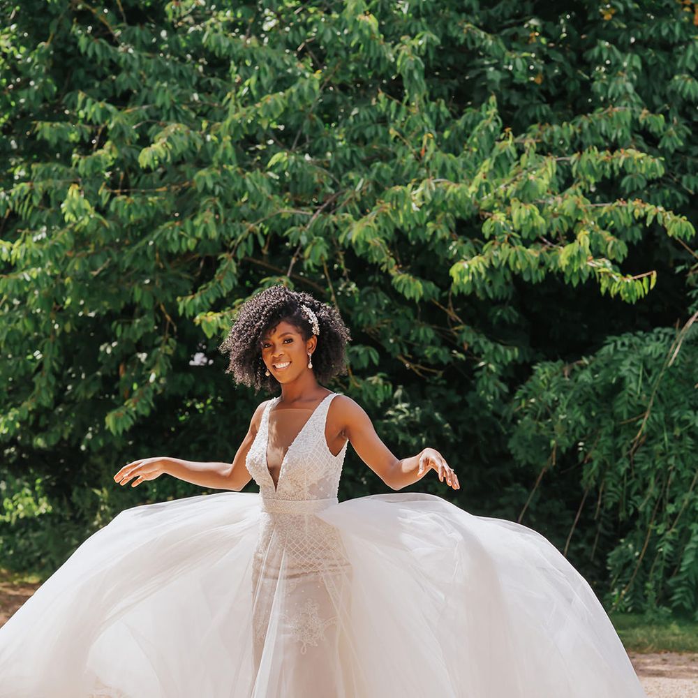 Black bride in a Ersa Atelier wedding dress with tulle skirt and embellished bodice with plunging neckline 