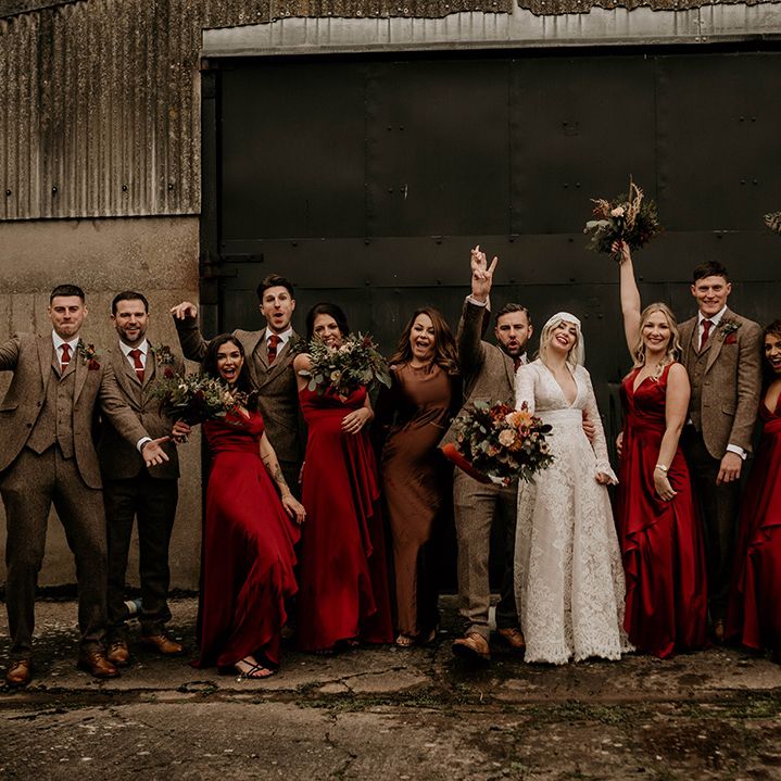 Lyde Court autumn wedding with wedding with groomsmen in brown suits and bridesmaids in red satin bridesmaid dresses 