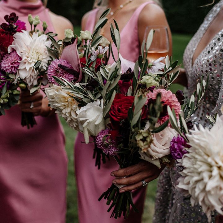 Wedding bouquets with pink, white and red dahlias, roses and foliage 