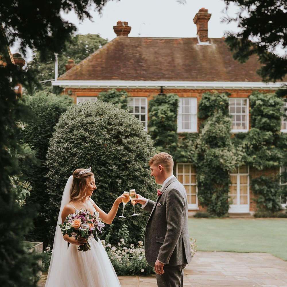 Bride and groom share a private toast at country house rustic wedding venue Micklefield Hall
