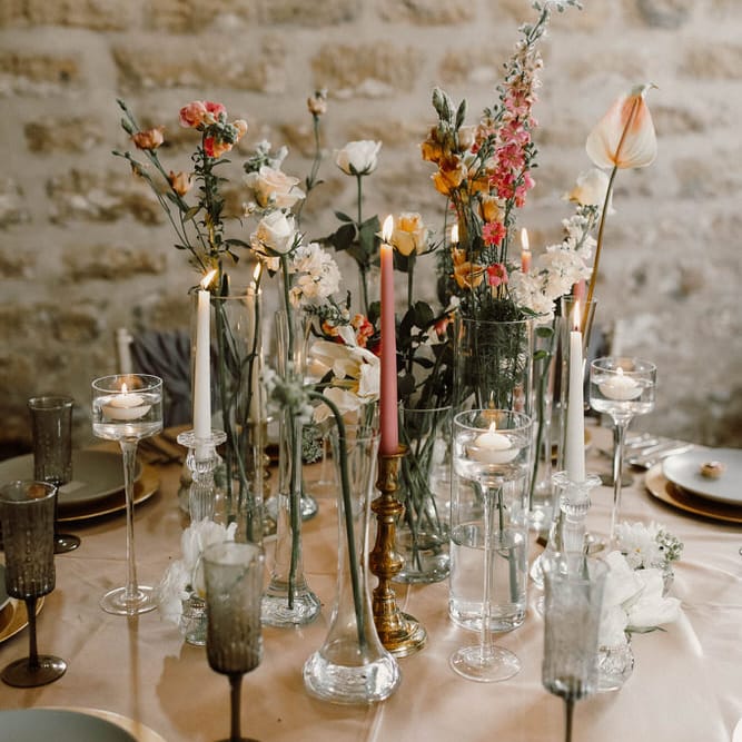 wedding table flower with flowers stems in different bottles and vases at Hooton Pagnell 