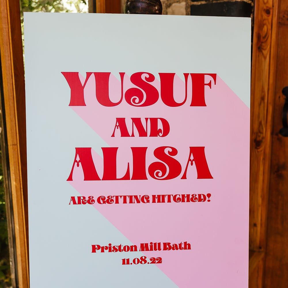 Modern wedding signage with 60s vibe and bright pink colour scheme