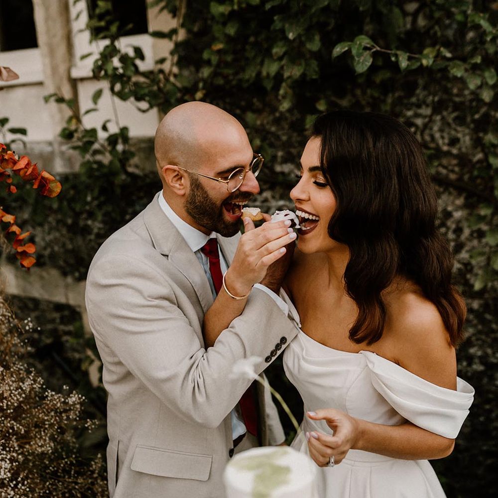 Bride and groom feed themselves some cake at their wedding 