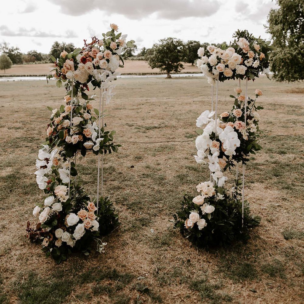 Rose and orchid flower columns with white and peach flowers 