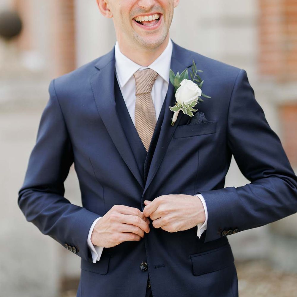 Groom in a navy three piece wedding suit 
