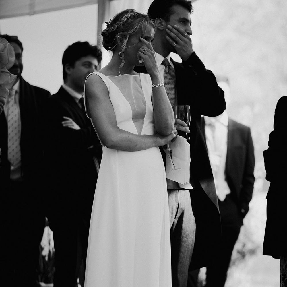 The bride and groom cry at the wedding speeches at there reception 