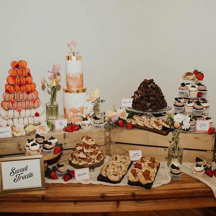 Yummy wedding dessert table filled with lots of sweet treats including macarons, cupcakes, flapjacks and cookies 